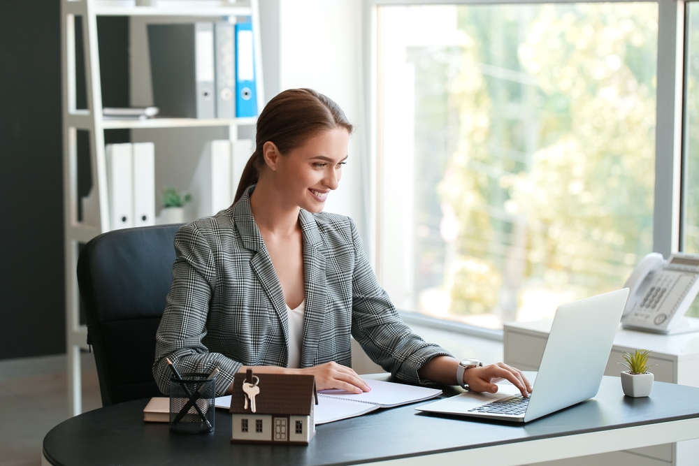Image of a real estate agent looking on a laptop